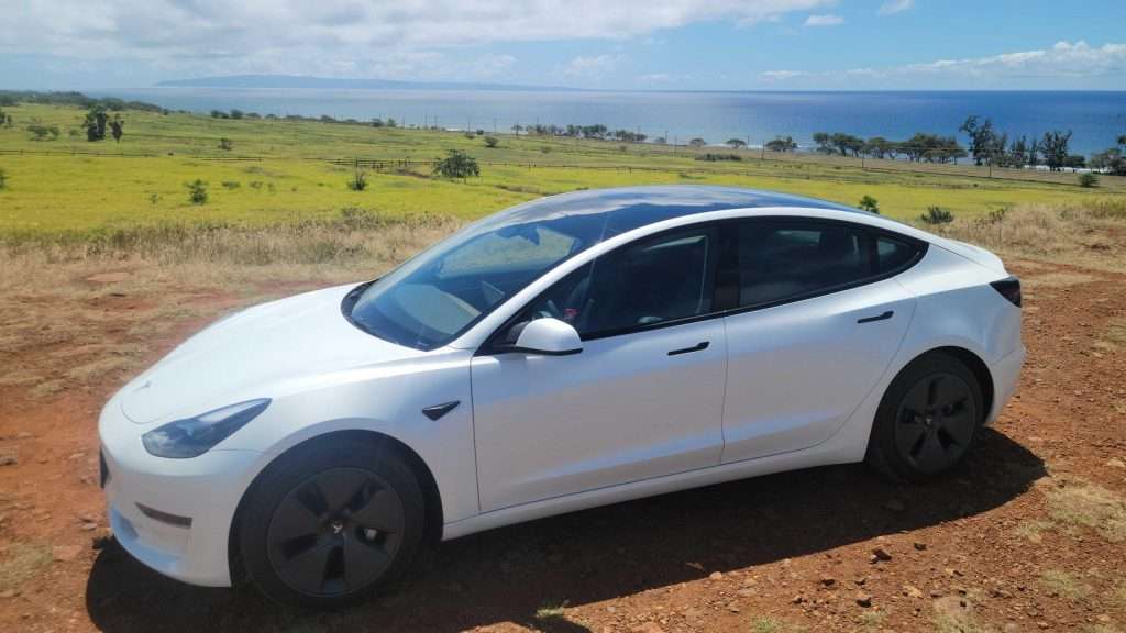 Tesla Model 3 in front of ocean view