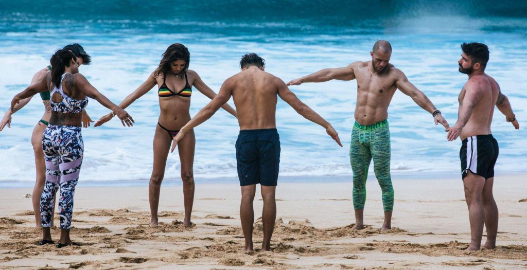 group stretching on the beach