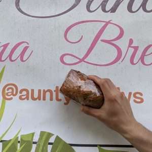 Aunty Sandy's Banana Bread in front of the shop sign on the Road to Hana