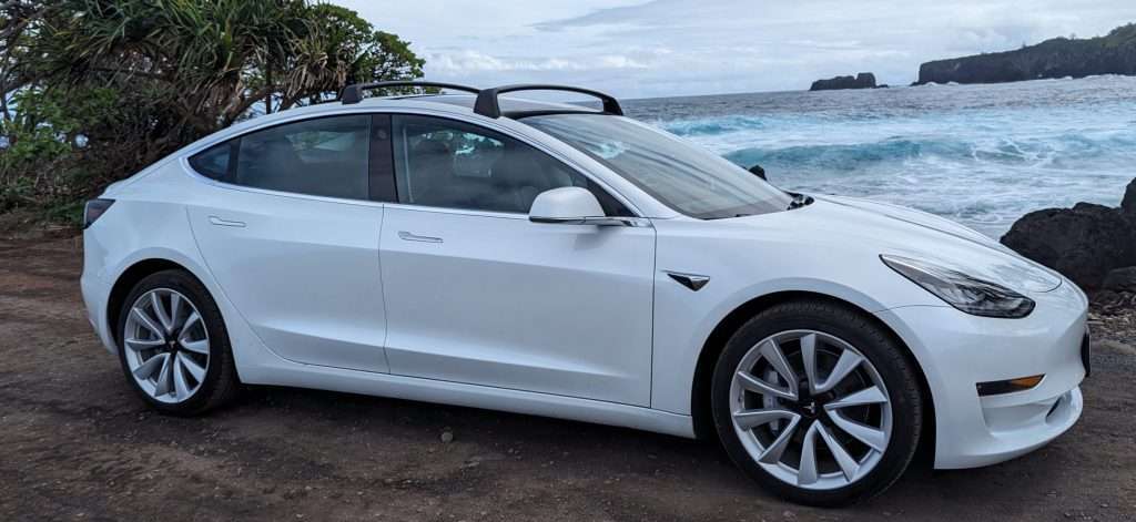 Tesla Model 3 parked in front of the ocean along the Road to Hana