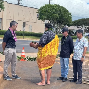 The Maui Telsa supercharger blessing ceremony as they are about to cut the line to open the stations to the public. Tom (Maui EVs), the kahuna, and other community members are present.